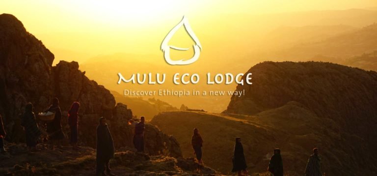 Sunrise over the Choke Mountains in Ethiopia with people walking near Mulu Eco Lodge, an eco volunteer project at the source of the Blue Nile