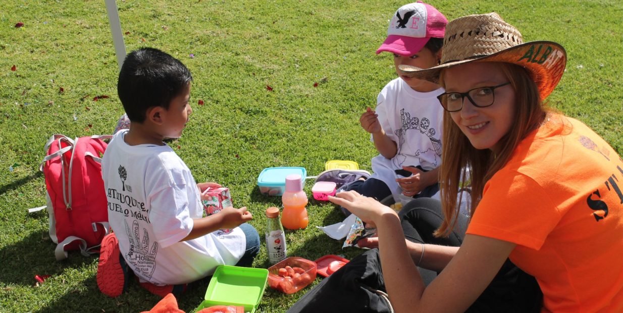 Volunteer spending time outdoors with children during a summer camp in Tlatlauquitepec, Puebla, Mexico.