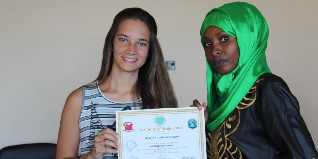 two volunteers showing participation certificates at Perspective Development Skills Charitable Organization