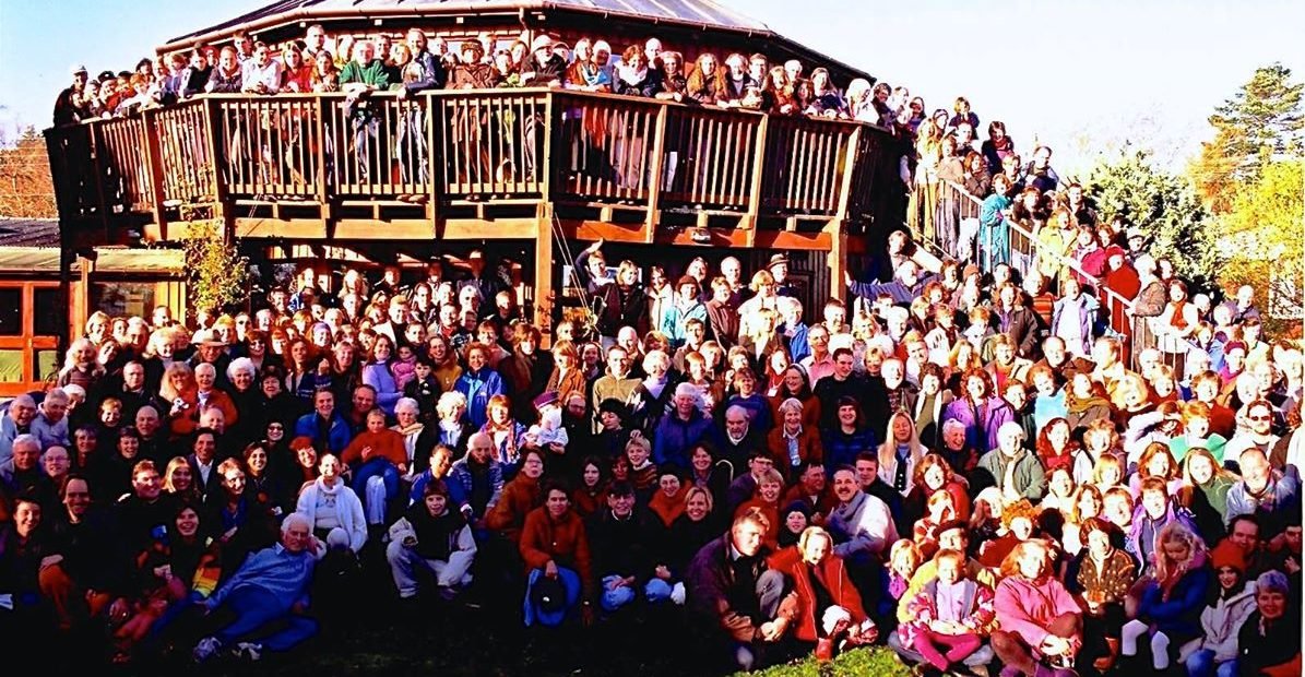 “Large group of volunteers and community members gathered at Findhorn Ecovillage in Scotland - part of the Global Ecovillage Network European Solidarity Corps programme promoting sustainability, education, and community living