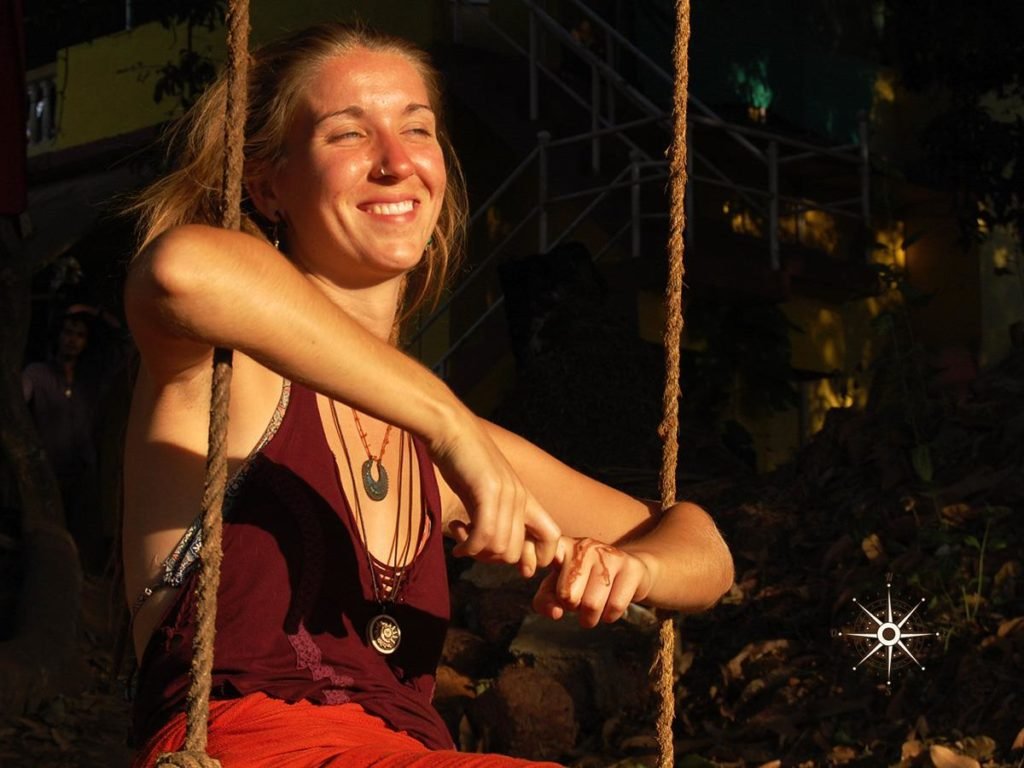 Female volunteer in a swing volunteering at No Name Hostel community in Goa India