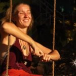 Female volunteer in a swing volunteering at No Name Hostel community in Goa India