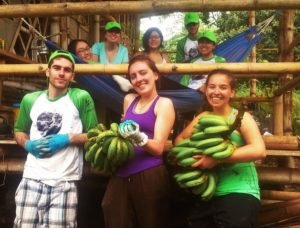 young volunteers holding bananas at Museo Ambiental in the Galapagos