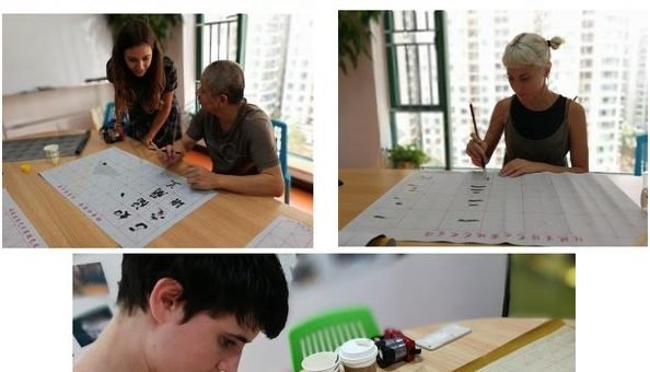 Qixing Au Pair China participants practice Chinese calligraphy during a Mandarin lesson in Shenzhen, learning brush strokes with teacher support.