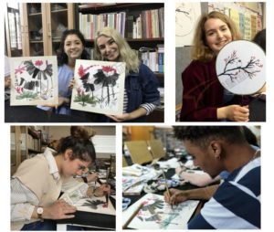 Qixing Au Pair China participants in Shenzhen learn traditional Chinese brush painting, creating lotus and plum blossom artworks during a cultural art class.