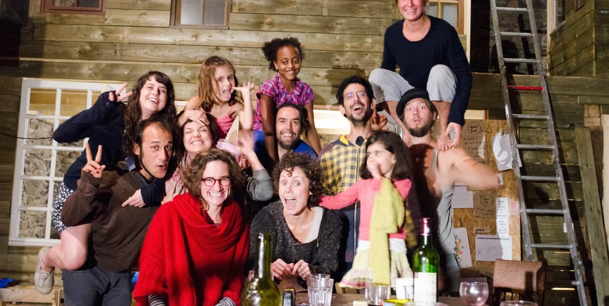 Group of young volunteers and artists smiling and posing together at Nomadways’ Homade residency in Brivezac, France, during a civic service program combining art, culture, and community work.