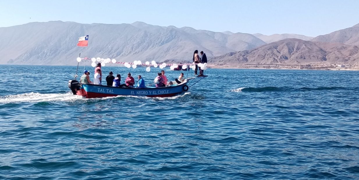Small boat full of volunteers and local people crossing the sea near Taltal, northern Chile, during a teaching English volunteer project and cultural exchange with EftG Language School and Voluntouring in South America.