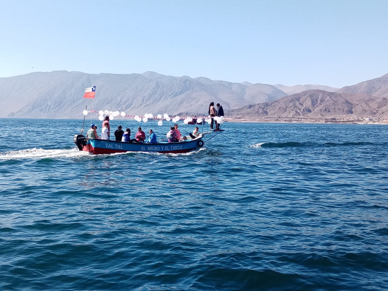Small boat full of volunteers and local people crossing the sea near Taltal, northern Chile, during a teaching English volunteer project and cultural exchange with EftG Language School and Voluntouring in South America.