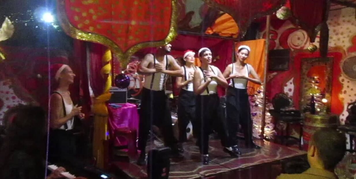 Volunteer performers on stage at Lotus Rouge art space in Playa del Carmen, Mexico