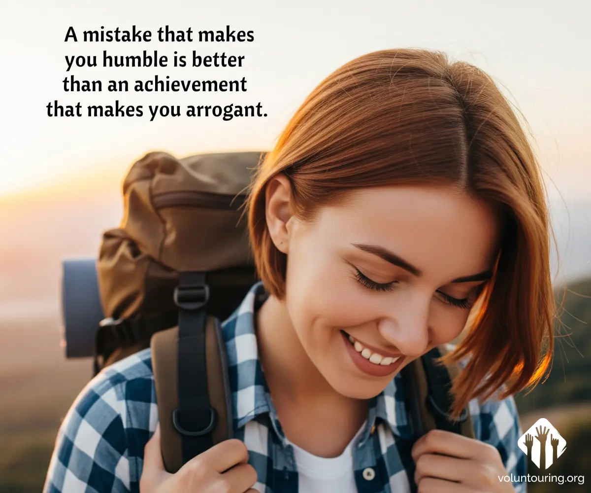 Close-up of a smiling young female backpacker with short auburn hair and a checkered shirt, carrying a brown hiking backpack at sunset. Quote reads, “A mistake that makes you humble is better than an achievement that makes you arrogant.”