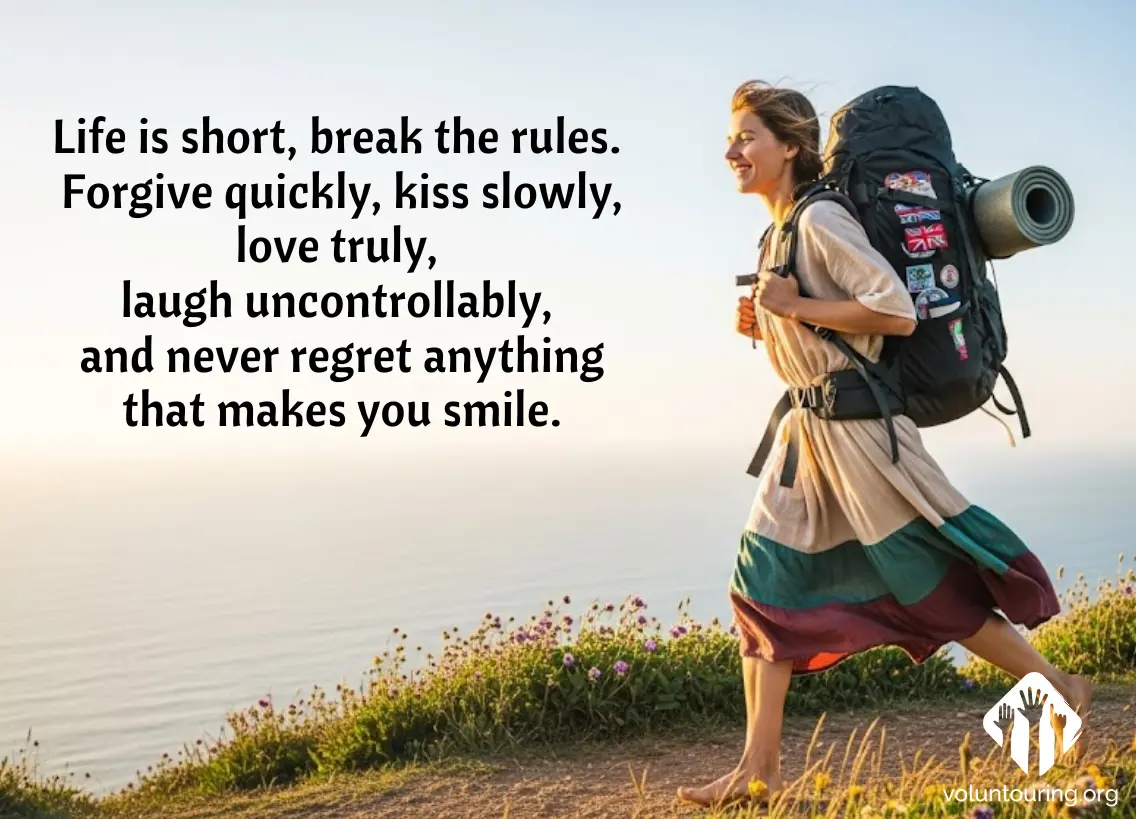 Smiling barefoot female backpacker walking along a coastal trail at golden hour, wearing a colorful travel dress and carrying a large patched backpack, with motivational quote about living freely and joyfully written beside her – Voluntouring.org