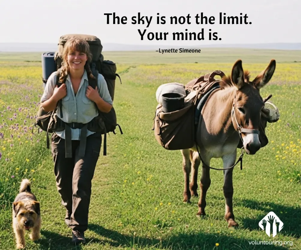 A smiling backpacker walking with a donkey and a dog across a green meadow under a clear sky, with the quote "The sky is not the limit. Your mind is." by Lynette Simeone – voluntouring.org.