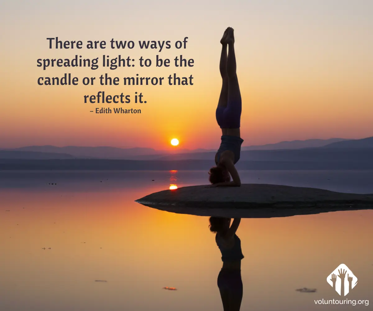 Person holding a headstand on a small rock in a calm lake at sunset, perfect reflection on the water. The image features the quote “There are two ways of spreading light: to be the candle or the mirror that reflects it” by Edith Wharton.