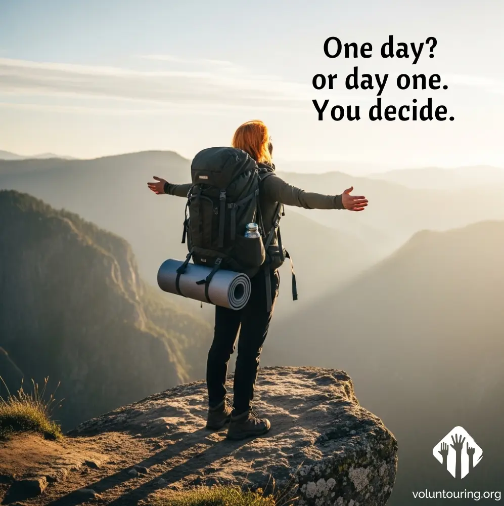Backpacker with arms open standing on a mountain cliff at sunrise, symbolizing freedom and new beginnings. Quote overlay reads: “One day? Or day one. You decide.” Voluntouring.org logo in the corner.