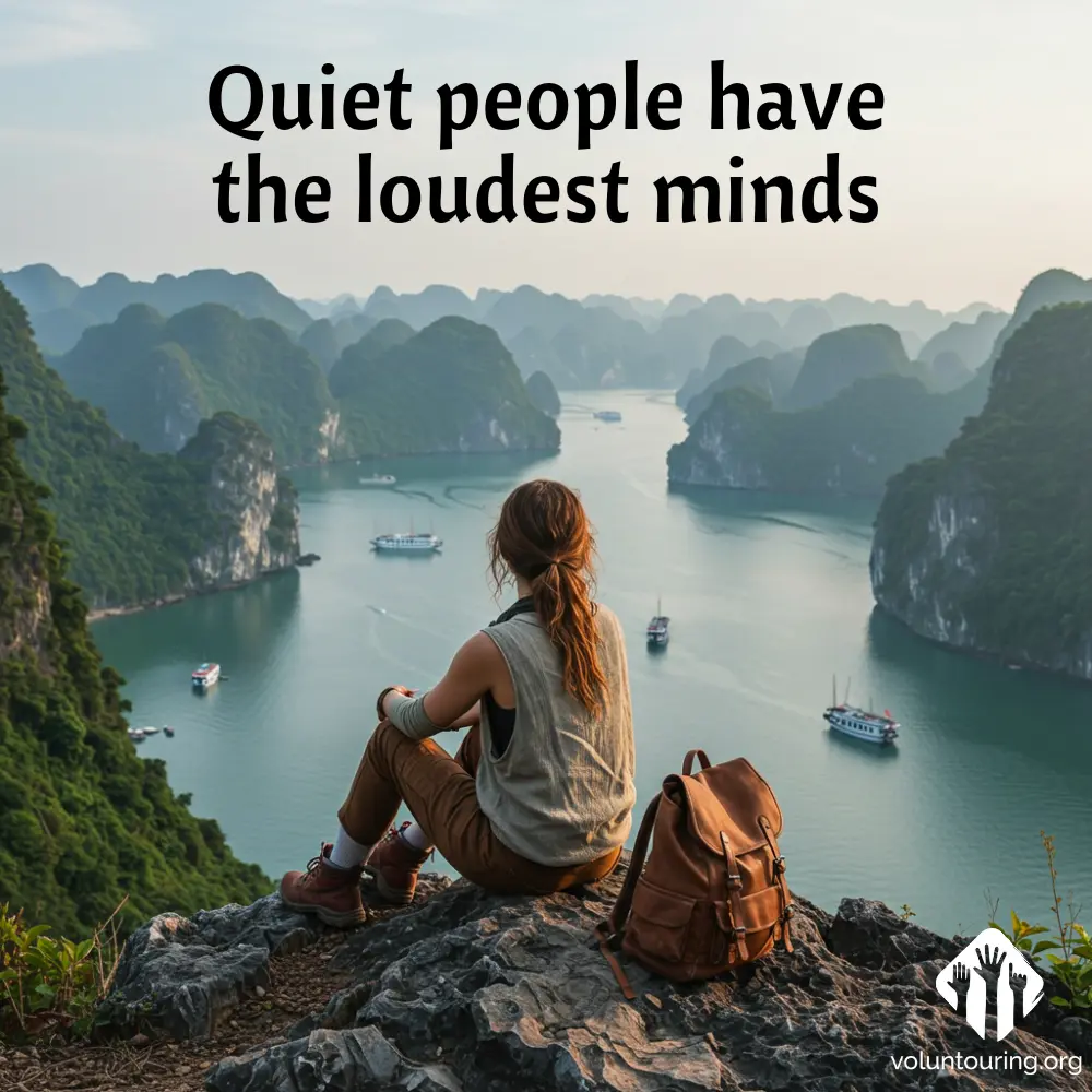 quote, Traveler sitting on cliffside overlooking Ha Long Bay’s limestone islands and calm emerald waters in northern Vietnam, voluntouring, voluntourism