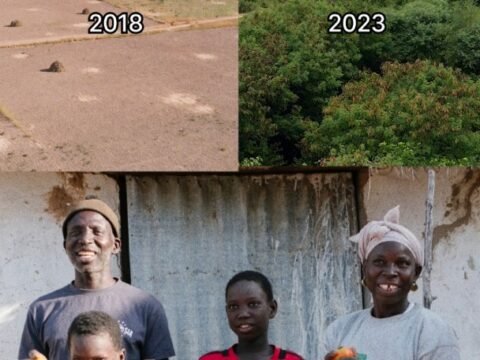 The Seck family smiling in front of their restored land in Senegal