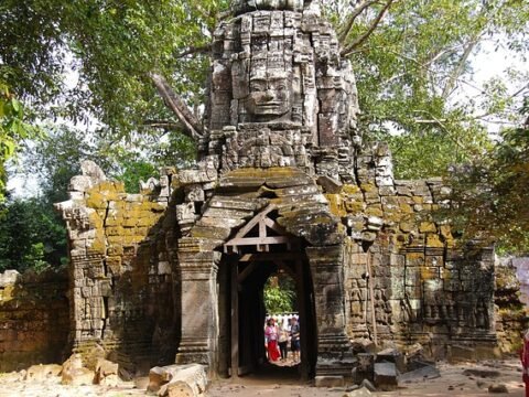 Stone entrance of Ta Som temple, featuring a face-tower in the Angkor archaeological park, Cambodia