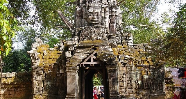 Stone entrance of Ta Som temple, featuring a face-tower in the Angkor archaeological park, Cambodia