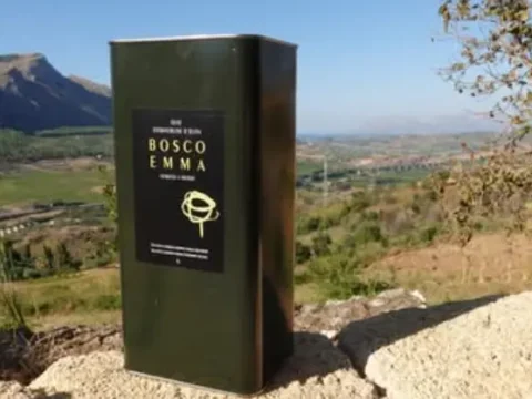 Bosco Emma extra-virgin olive oil tin with panoramic view of Segesta valley, Calatafimi Segesta, Trapani, Sicily.