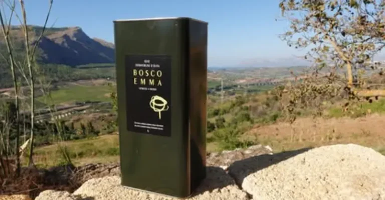Bosco Emma extra-virgin olive oil tin with panoramic view of Segesta valley, Calatafimi Segesta, Trapani, Sicily.