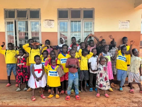 Group of children outside a community school in Bugembe, Jinja Uganda, part of Mothers and Children Uganda’s volunteer program