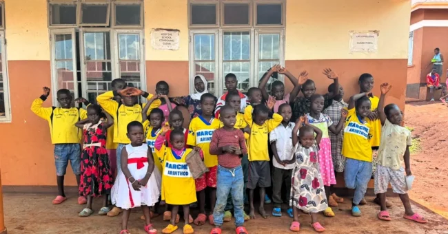 Group of children outside a community school in Bugembe, Jinja Uganda, part of Mothers and Children Ugandaโs volunteer program