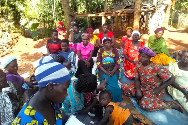 Women and children at a community support meeting in Bugembe, Jinja Uganda, organized by Mothers and Children Uganda.
