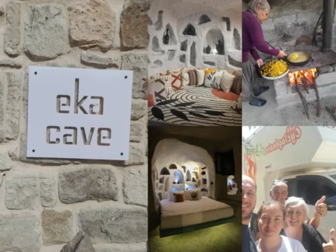 Eka Cave Maison in Cappadocia – stone sign, carved cave suite with niche shelves, local woman cooking on wood fire, and happy guests by a camper.
