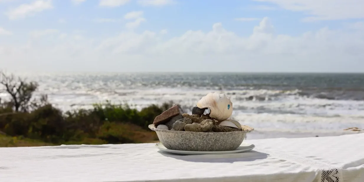 Volunteer pastry chef role at a beach guesthouse on Uruguay’s coast, seashells and ocean view.