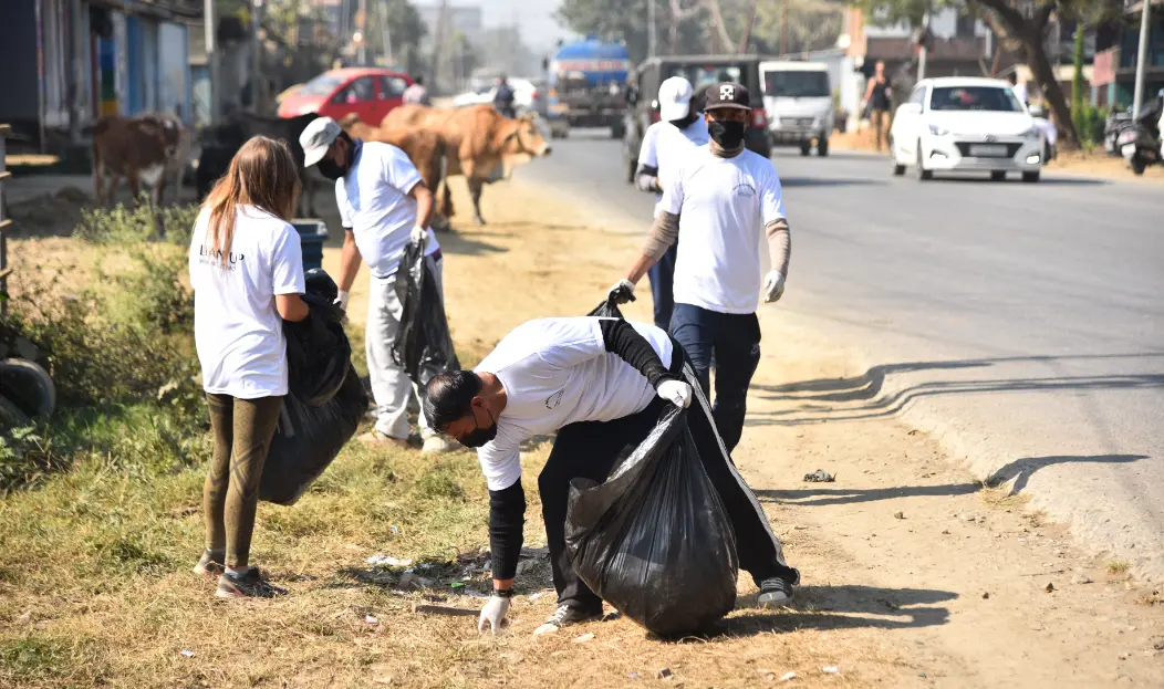Volunteer in Manipur India at Langon Sanglen: volunteers cleaning the roadside near Imphal during a community environmental project.