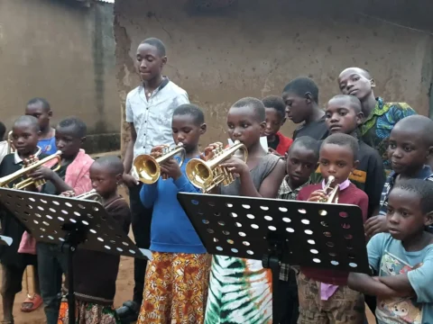 Children learning to play brass instruments at the Educate Brass Foundation community music program in Shuuku Sheema, Uganda.