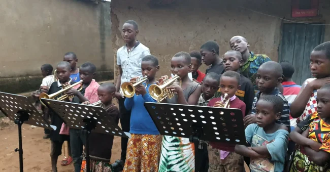 Children learning to play brass instruments at the Educate Brass Foundation community music program in Shuuku Sheema, Uganda.