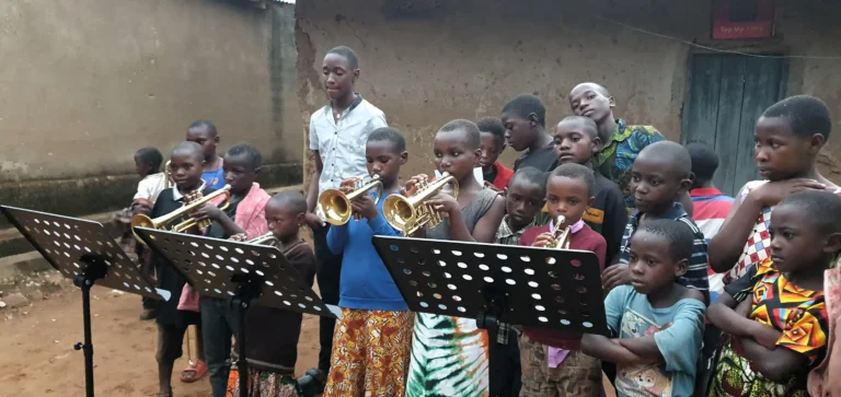Children learning to play brass instruments at the Educate Brass Foundation community music program in Shuuku Sheema, Uganda.