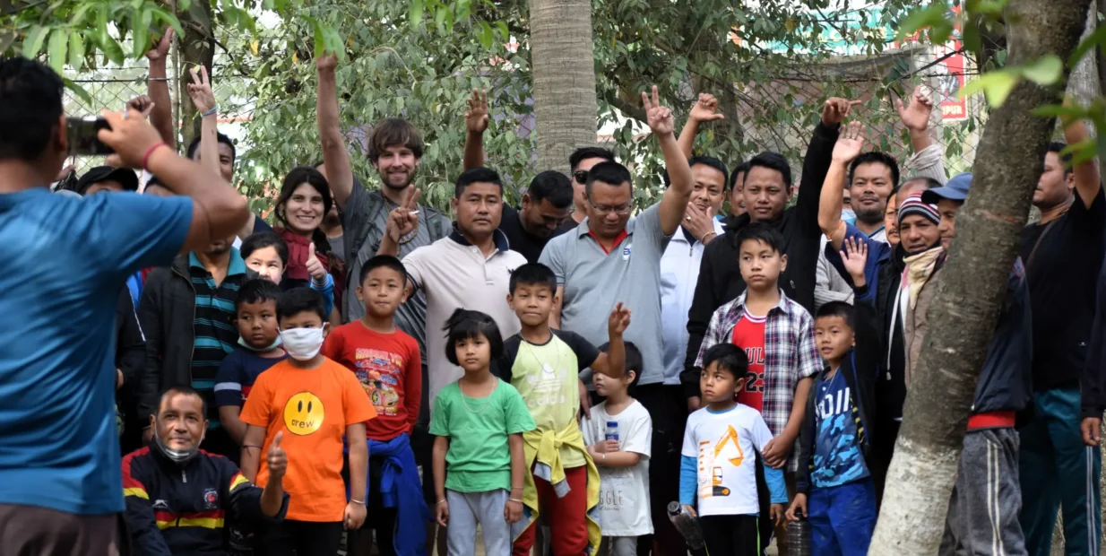 Volunteer in Manipur India: group photo of volunteers and local children at Langon Sanglen wellness centre garden near Imphal.