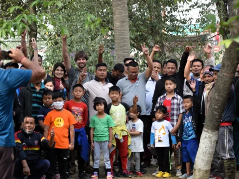 Volunteer in Manipur India: group photo of volunteers and local children at Langon Sanglen wellness centre garden near Imphal.