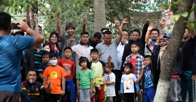 Volunteer in Manipur India: group photo of volunteers and local children at Langon Sanglen wellness centre garden near Imphal.