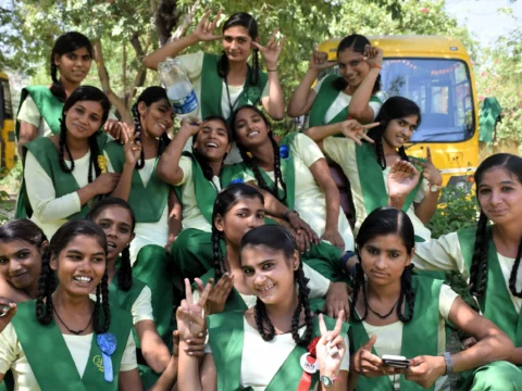 Volunteer opportunity in rural India with smiling schoolgirls in green uniforms at a girls’ school in Anupshahr, Uttar Pradesh