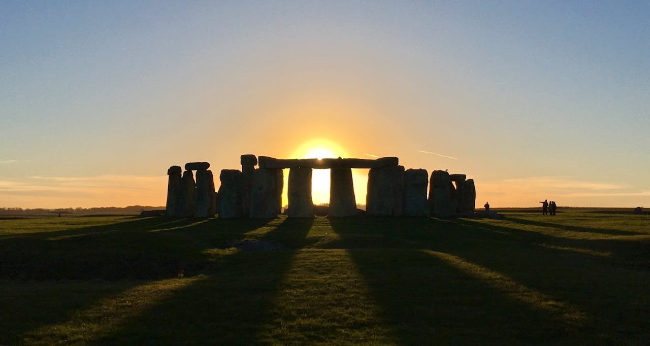 Stonehenge at sunrise on Salisbury Plain, with the low sun aligned through the stone circle, showing the link between Stonehenge and the solstice sky in England.