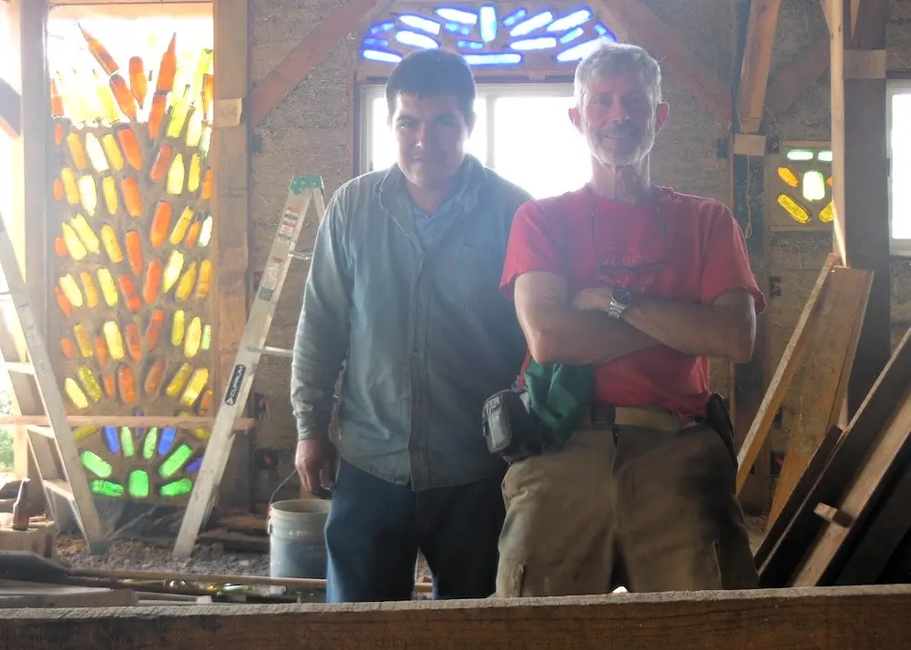 Colourful glass bottle wall inside a natural building workspace at Roca de Hadas, South Jalisco, Mexico.