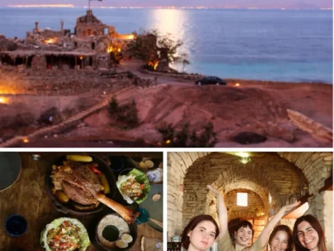 Castle Zaman stone buildings on a private Red Sea beach in South Sinai, Egypt. Slow food dinner table Seasonal team photo inside stone-arched dining room