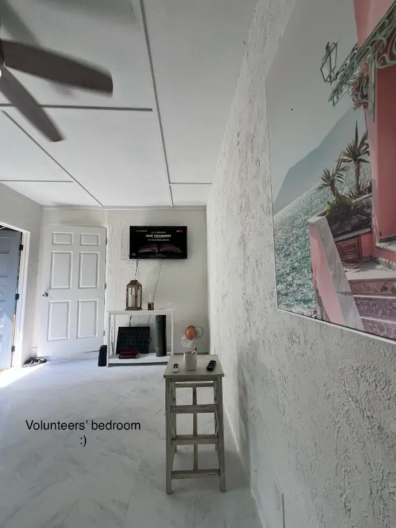 Shared helper volunteer bedroom at Hawaii rainforest work exchange for women in Volcano, featuring simple furnishings and hostel-style setup in off-grid B&B.