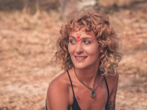 Person at an outdoor Rainbow Gathering, symbolic image for conscious participation, community values and alternative travel in nature.