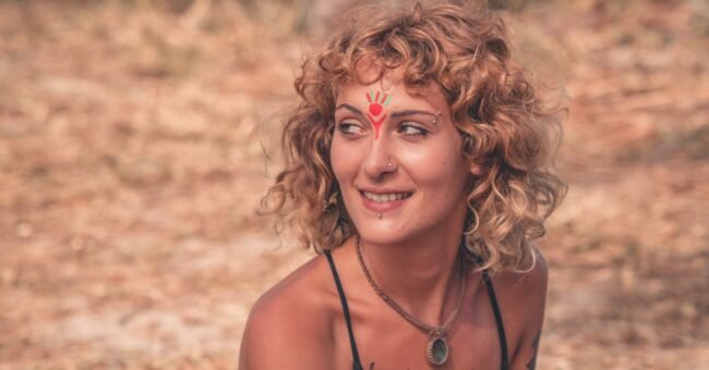 Person at an outdoor Rainbow Gathering, symbolic image for conscious participation, community values and alternative travel in nature.