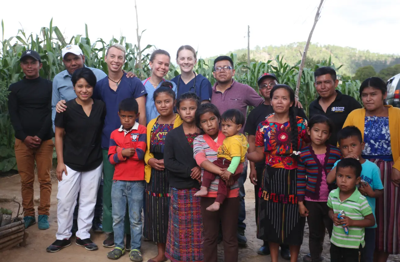 Health & Help medical volunteers with local community members during rural healthcare outreach in Totonicapán, Guatemala, supporting access to basic medical care.