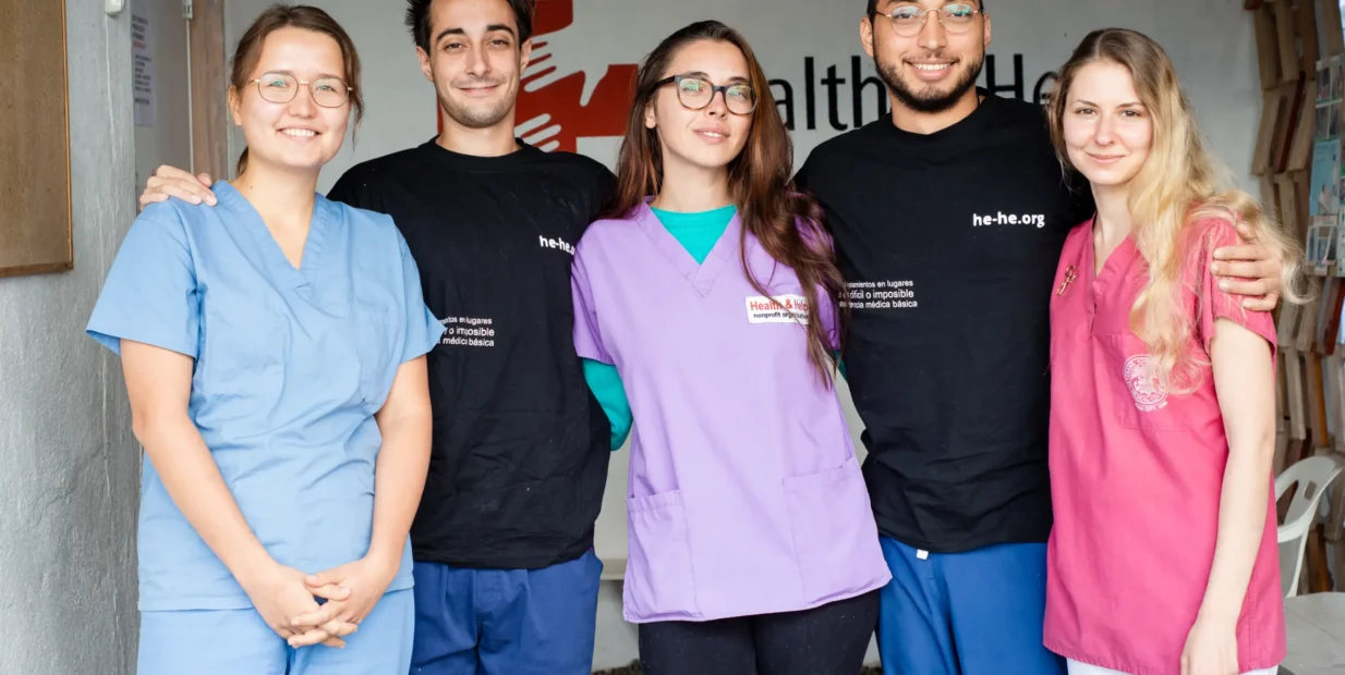 Health & Help medical staff and volunteers in scrubs at a rural healthcare clinic in Guatemala, supporting community medical care in Totonicapán.