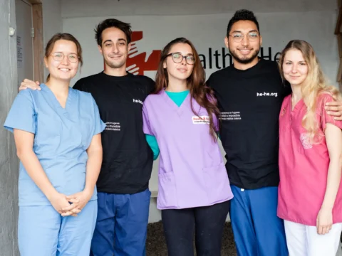 Health & Help medical staff and volunteers in scrubs at a rural healthcare clinic in Guatemala, supporting community medical care in Totonicapán.