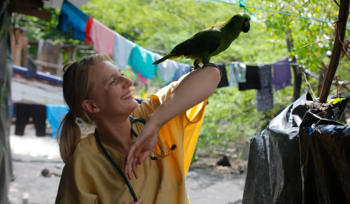 Health & Help medical volunteer with a stethoscope in rural Guatemala, supporting community healthcare services in a natural highland setting.