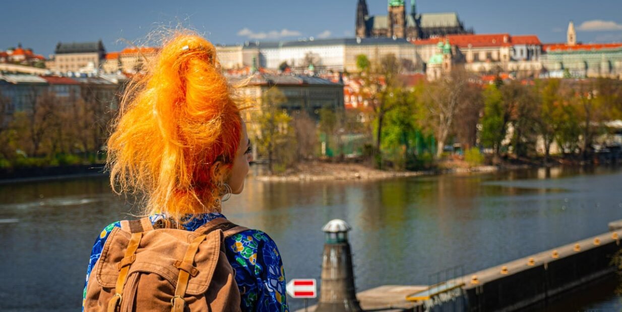 Volunteer in Prague with IYNF, young traveller overlooking the city skyline in the Czech Republic.