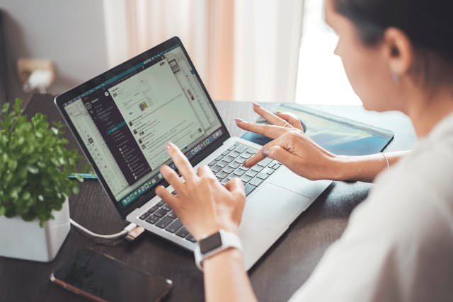 Volunteer using a laptop to check host profiles, websites and social media before joining a volunteer exchange project.
