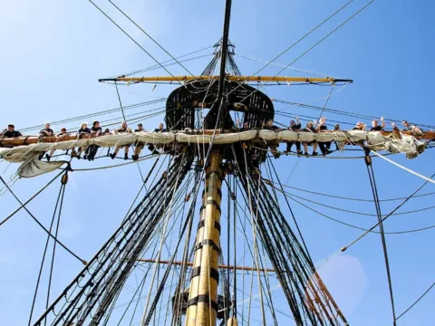 Volunteers working high in the rigging of the Götheborg wooden ship in Gothenburg, Sweden, during a ship volunteering opportunity.